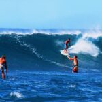 Stand up paddle surfing on the huge waves off Sunset Beach