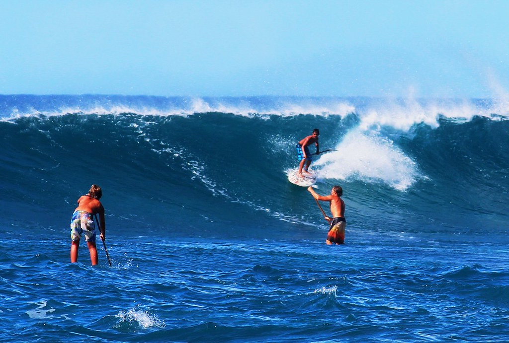 Stand up paddle surfing on the huge waves off Sunset Beach